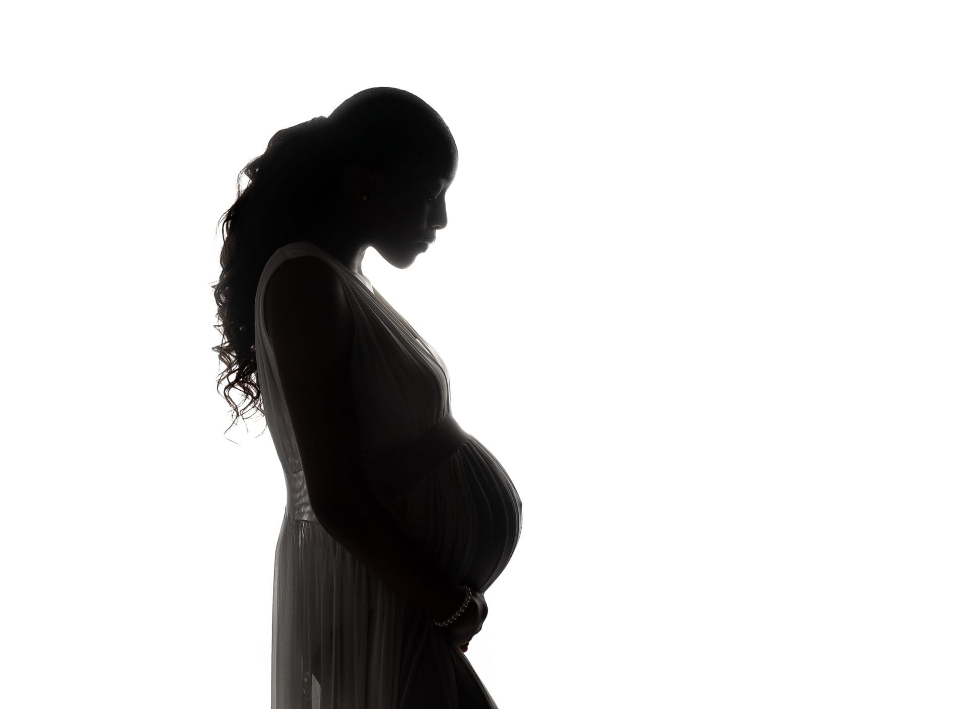 A silhouette of a pregnant mom in the studio with New Orleans birthing center.