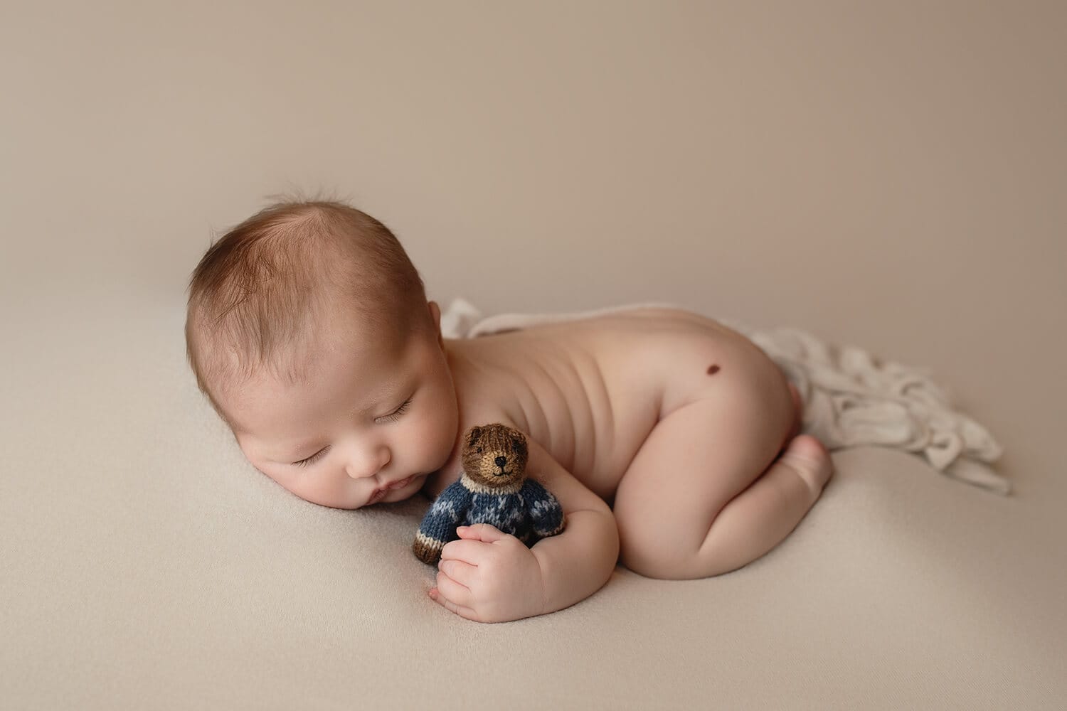 baby boy with bear lovey