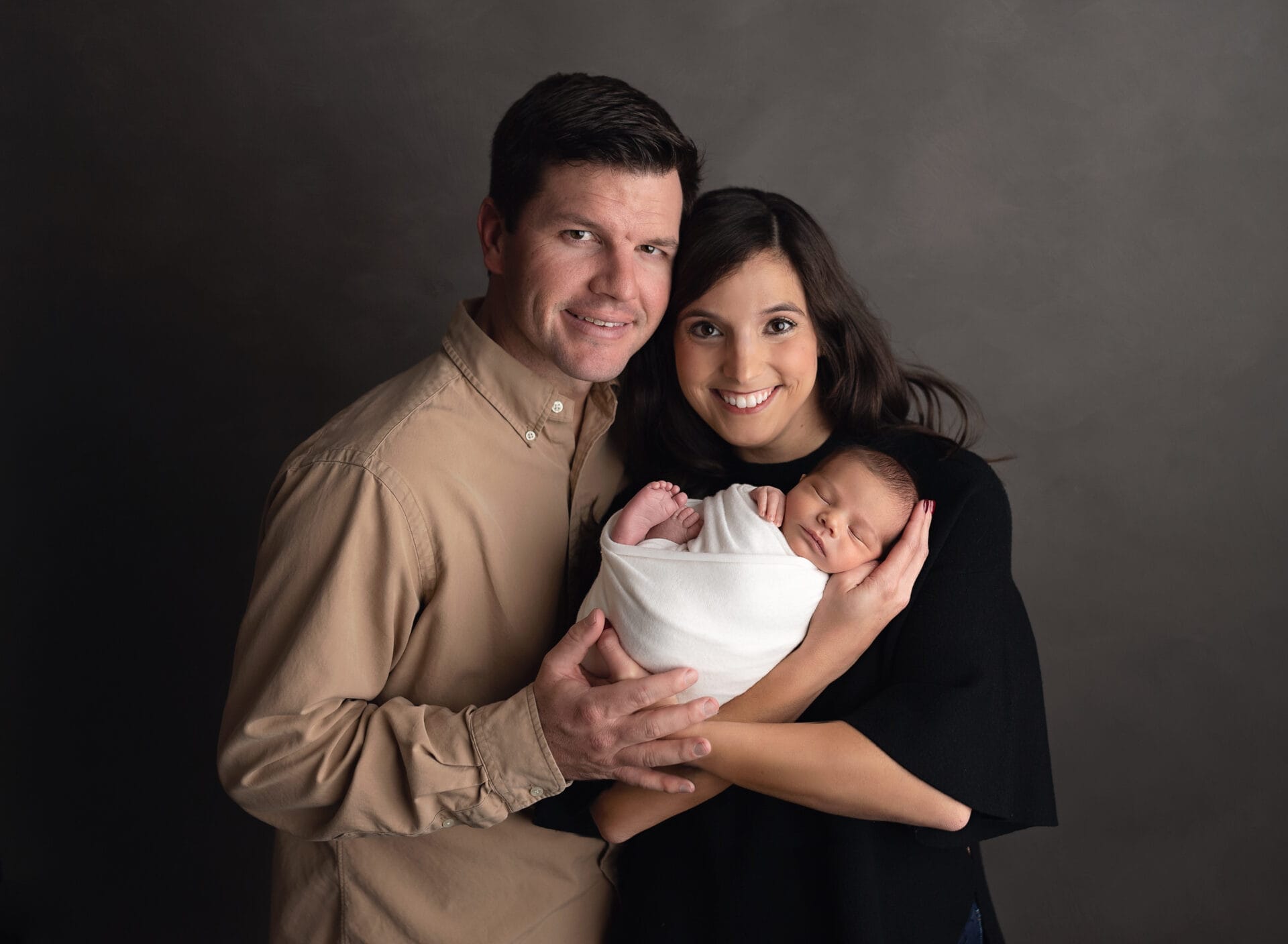 New Baton Rouge parents embracing their baby boy in the studio with Melinda Gilmore Photography.